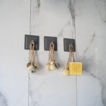 Load image into Gallery viewer, Dragon Fruit, Papaya & Carrot Soap hanging on hooks with decorative clay beads on a marble wall.